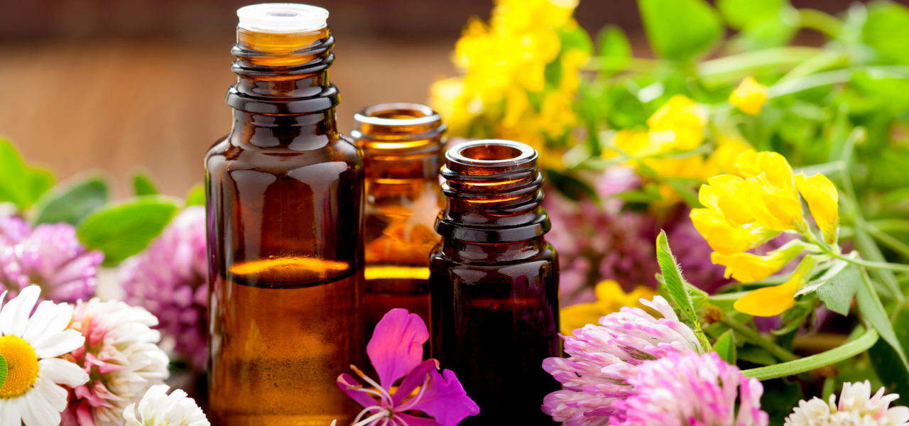 Image of three essential oils with spring flowers